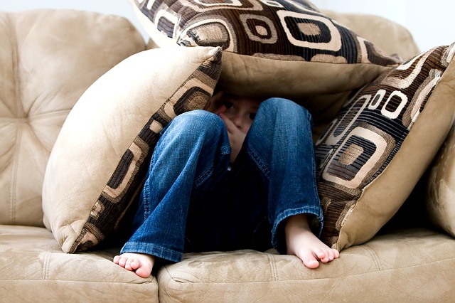 boy under pillows afraid - Dental Anxiety and Fear: Impact on Oral Health