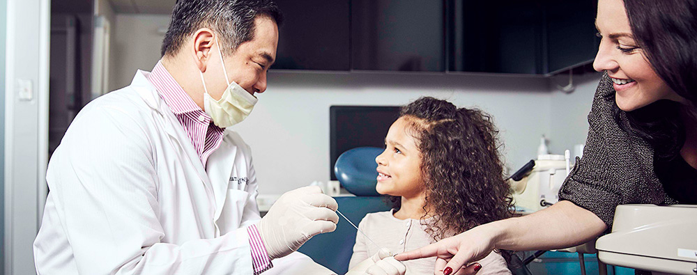 pediatric dentist with child - Dental Practitioners – Some Distinctions Between Pediatric Dentists and Other Types of Dentistry